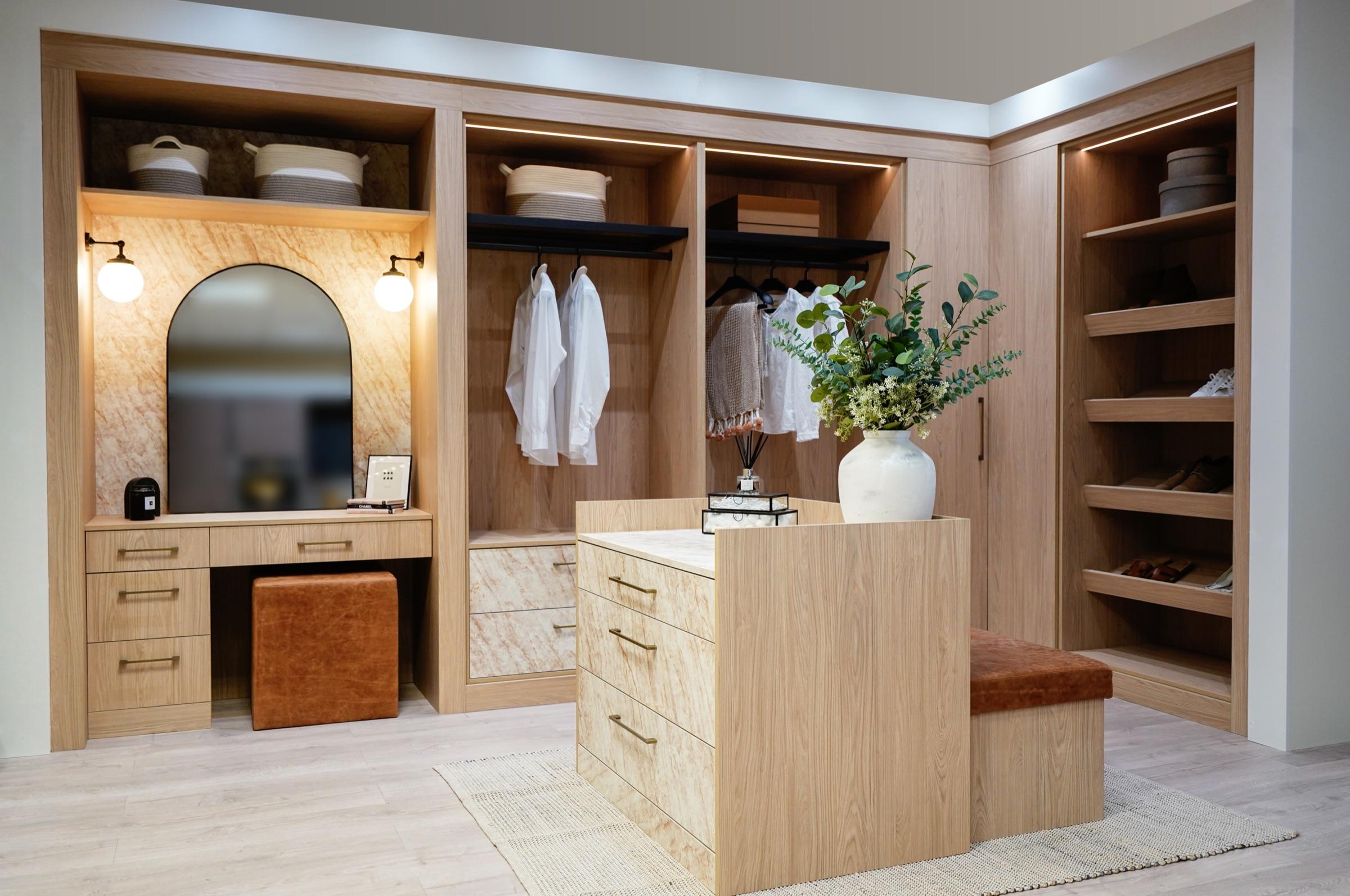 Oak walk-in dressing room with a dressing table, open hanging space and shoe shelving